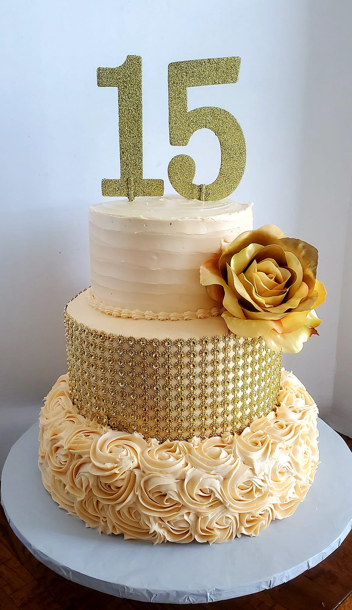 Beautiful 15th birthday celebration cake with gold accents